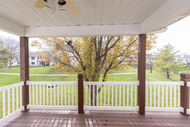 deck with a yard and ceiling fan