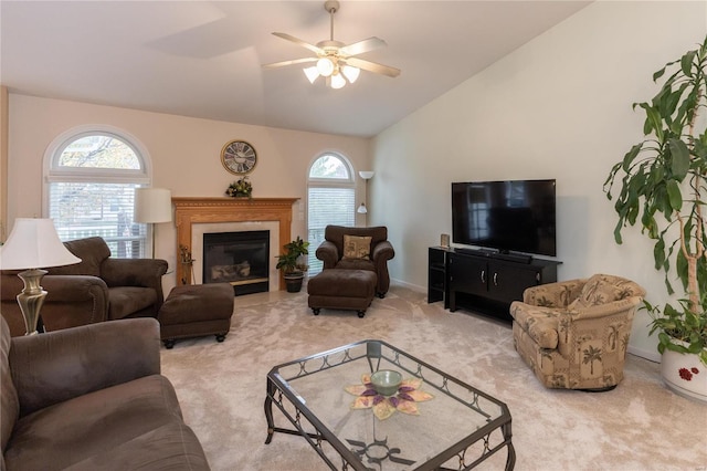 living room featuring ceiling fan, light colored carpet, a healthy amount of sunlight, and lofted ceiling