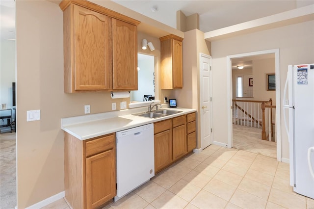 kitchen featuring white appliances, light colored carpet, and sink