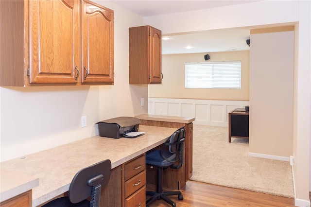 office area featuring light wood-type flooring and built in desk