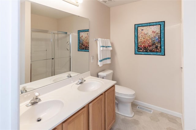 bathroom with a shower with door, vanity, and toilet