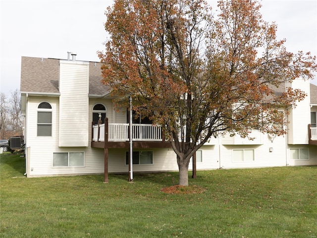 back of house with a lawn and central air condition unit