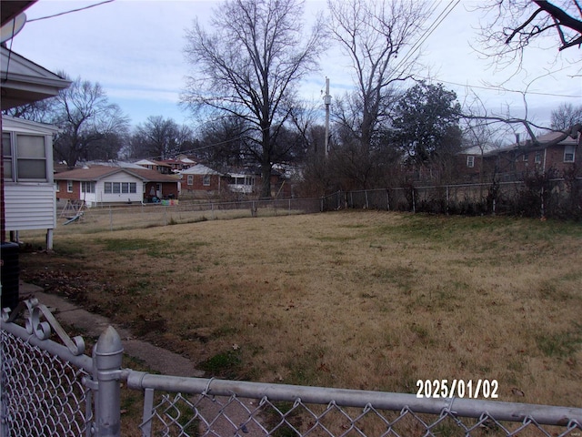 view of yard featuring a residential view and fence