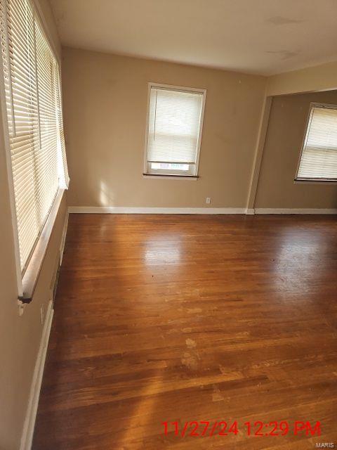 empty room featuring baseboards and wood finished floors