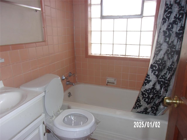 bathroom with shower / tub combo with curtain, vanity, and tile walls