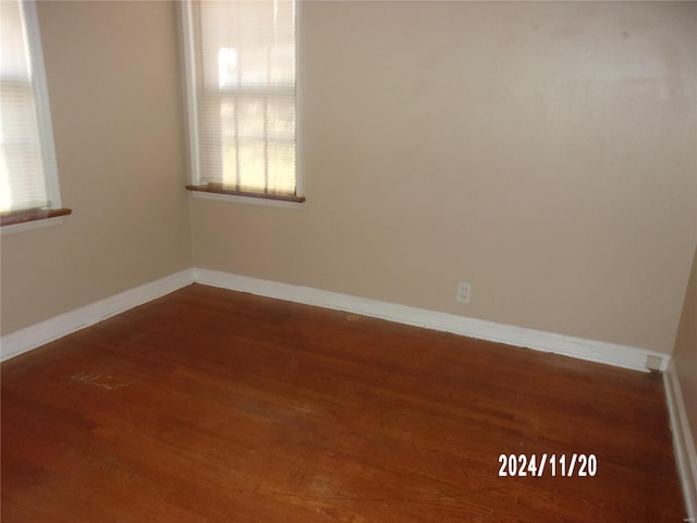 unfurnished room with wood finished floors and baseboards