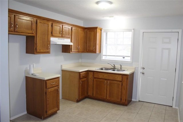 kitchen featuring light tile patterned floors and sink