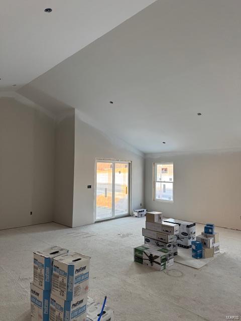 living room featuring lofted ceiling