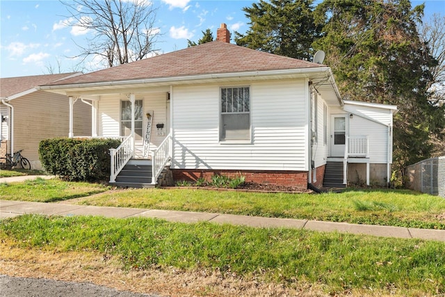 bungalow-style home featuring a front lawn