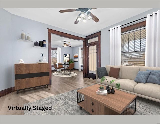 living room featuring hardwood / wood-style floors and ceiling fan