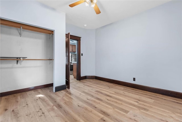 unfurnished bedroom featuring ceiling fan, light hardwood / wood-style floors, and a closet