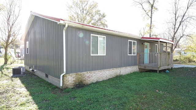 exterior space with a lawn and central AC unit