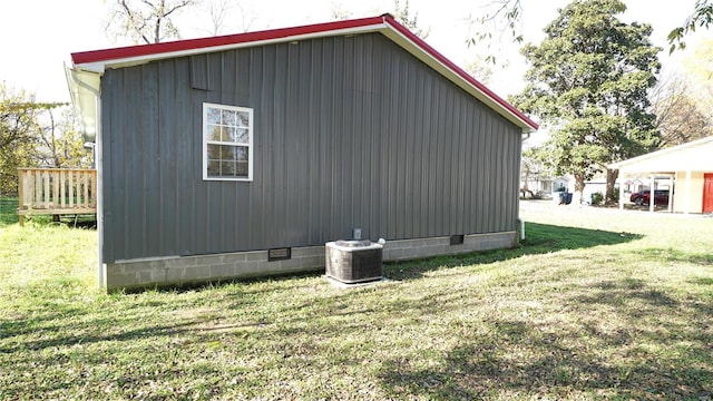 view of home's exterior with cooling unit, a wooden deck, and a lawn