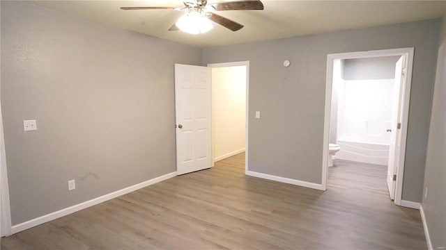 unfurnished bedroom with connected bathroom, ceiling fan, and light hardwood / wood-style flooring