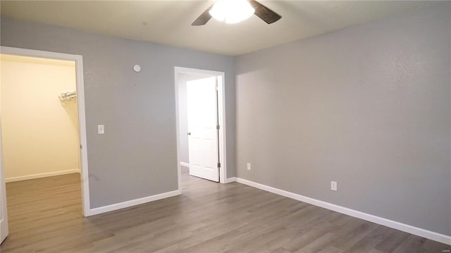 empty room featuring hardwood / wood-style flooring and ceiling fan