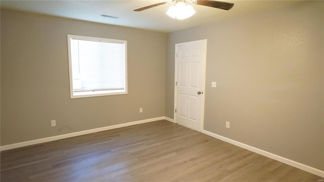 unfurnished room featuring hardwood / wood-style flooring and ceiling fan