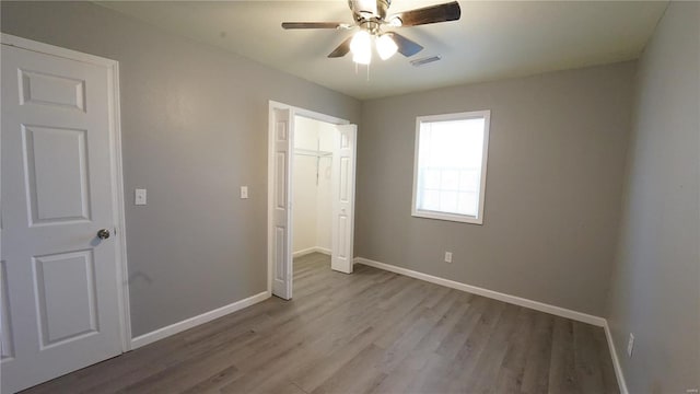 unfurnished bedroom featuring ceiling fan and light wood-type flooring