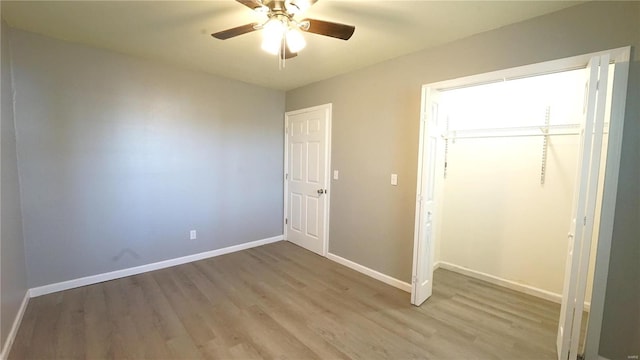 unfurnished bedroom with ceiling fan, a closet, and light hardwood / wood-style floors