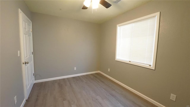 empty room with light wood-type flooring and ceiling fan