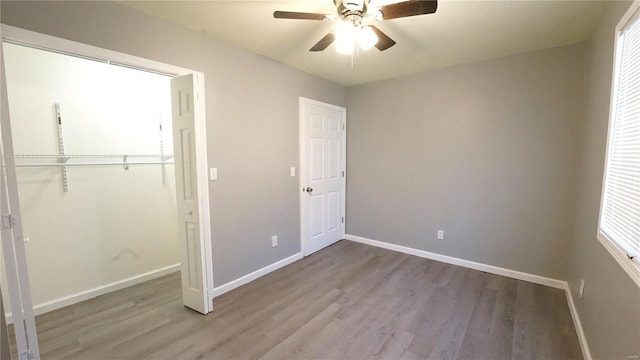 unfurnished bedroom featuring ceiling fan, a closet, and light hardwood / wood-style flooring