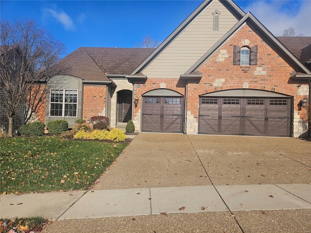 view of front of house with a garage and a front lawn