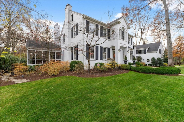 colonial inspired home with a front yard