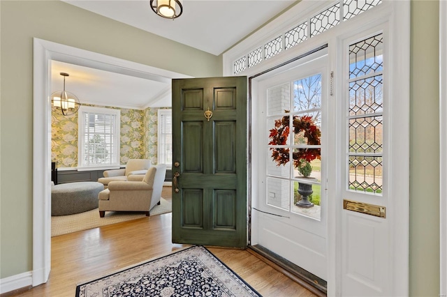 entryway featuring plenty of natural light, a chandelier, and light hardwood / wood-style flooring