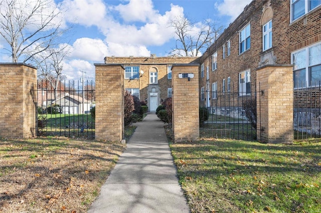 view of gate featuring a lawn