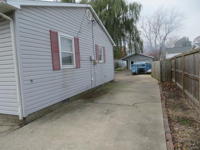 view of home's exterior featuring a garage and an outbuilding