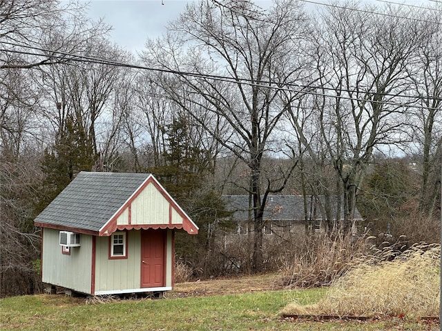 view of outbuilding with a wall unit AC