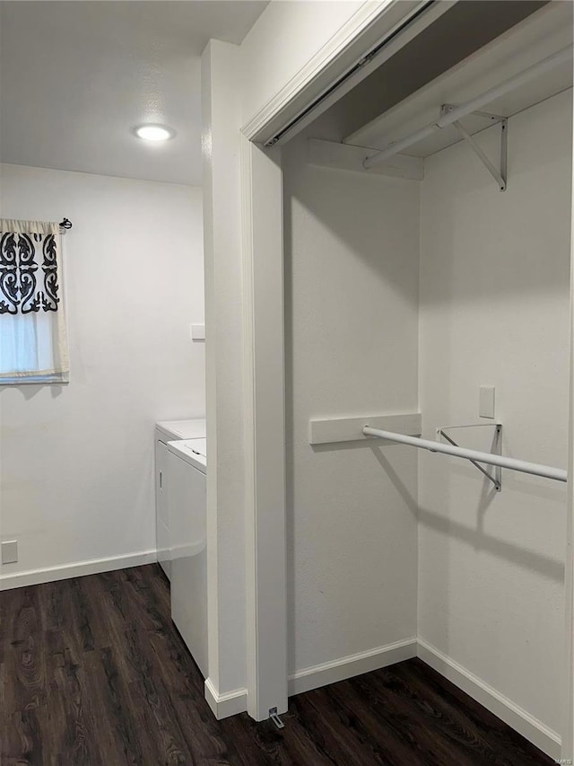 walk in closet featuring dark hardwood / wood-style flooring and washing machine and clothes dryer