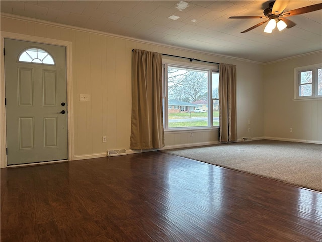 entrance foyer with ceiling fan, crown molding, and dark wood-type flooring