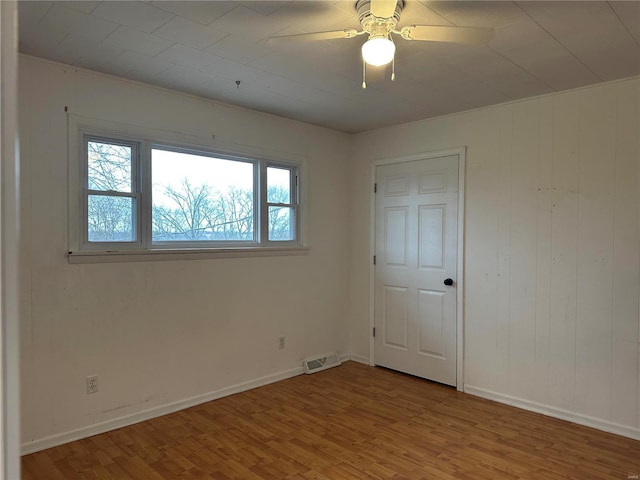 spare room featuring light wood-type flooring and ceiling fan