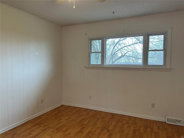 spare room with light hardwood / wood-style flooring