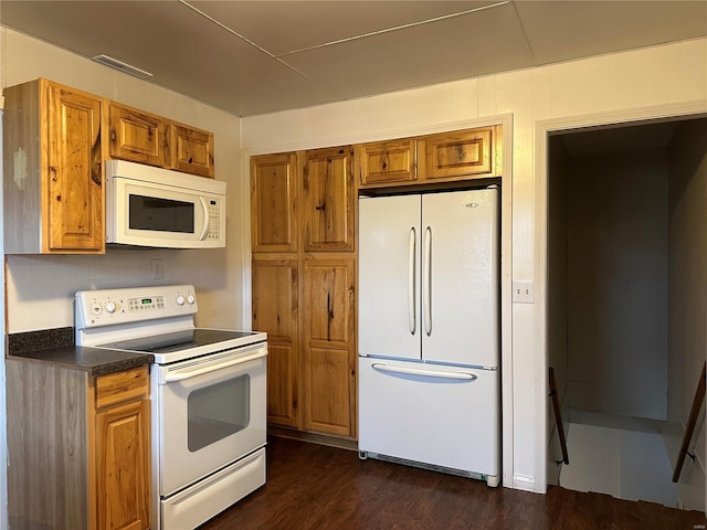 kitchen featuring dark hardwood / wood-style floors and white appliances