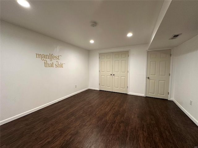 unfurnished bedroom featuring dark hardwood / wood-style flooring and a closet