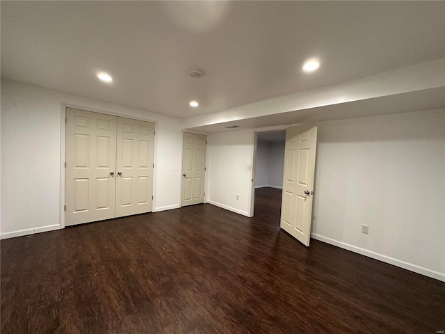 basement with dark hardwood / wood-style floors