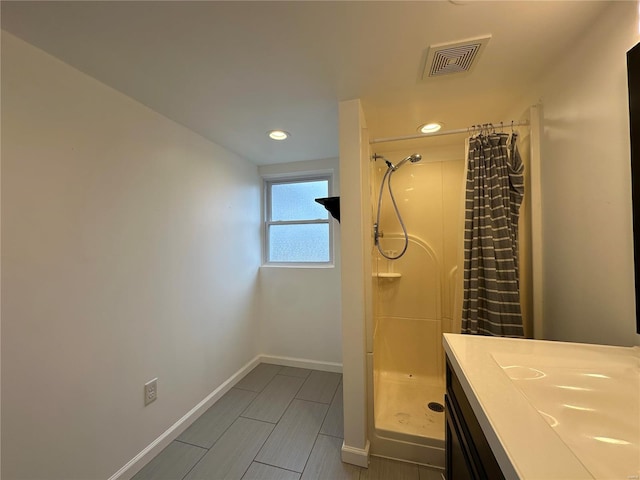 bathroom with walk in shower and sink