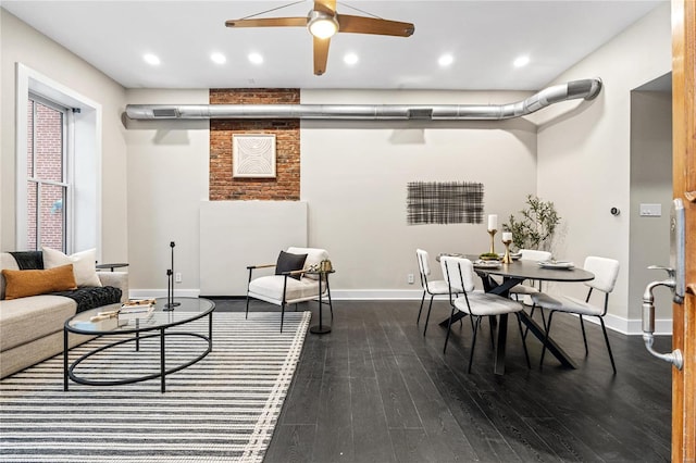 living room featuring dark hardwood / wood-style flooring and ceiling fan