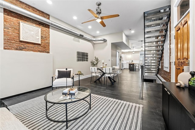 living room featuring dark hardwood / wood-style floors and ceiling fan