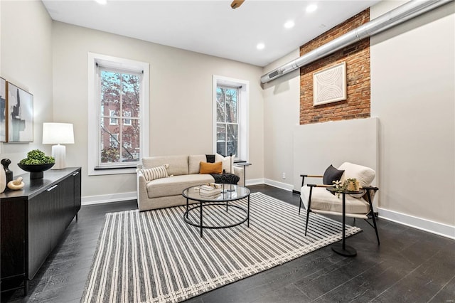 sitting room featuring plenty of natural light and dark hardwood / wood-style floors