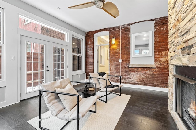 interior space with ceiling fan, french doors, and an outdoor stone fireplace