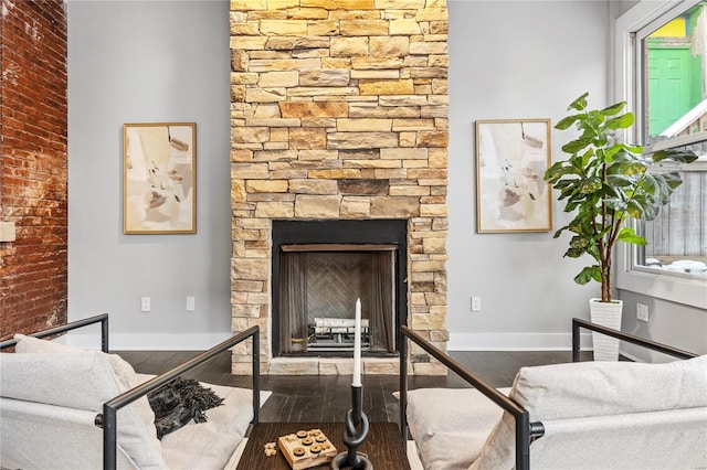 living room with dark hardwood / wood-style flooring and a fireplace