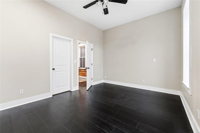 spare room with ceiling fan and dark hardwood / wood-style floors