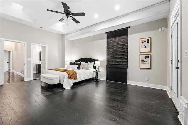 bedroom featuring ceiling fan, dark hardwood / wood-style floors, and connected bathroom