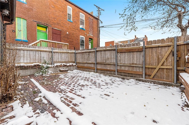 yard layered in snow featuring a patio area