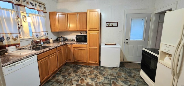 kitchen with black appliances, a healthy amount of sunlight, and dark stone counters