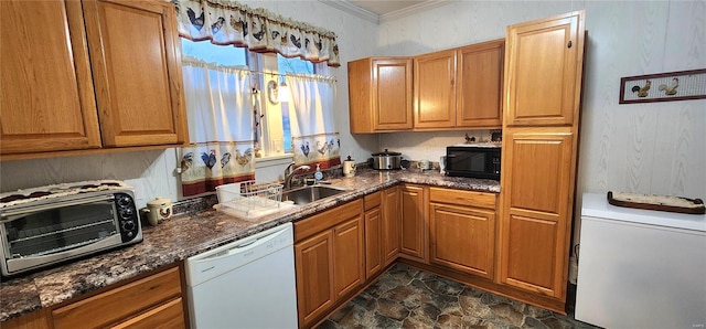 kitchen featuring sink, white appliances, crown molding, and dark stone countertops