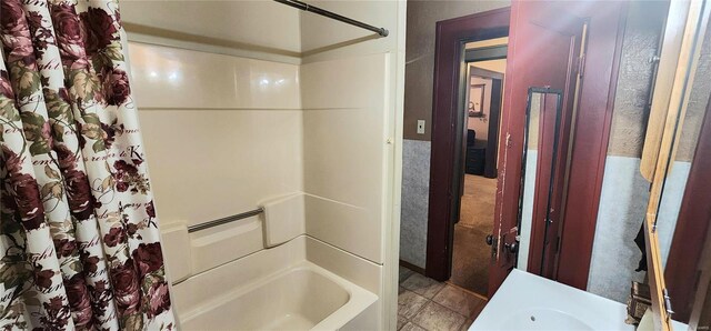 bathroom with tile patterned floors and shower / tub combo