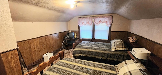 bedroom featuring wood walls and lofted ceiling